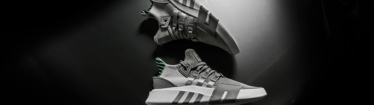 Two sneakers with a dark background
